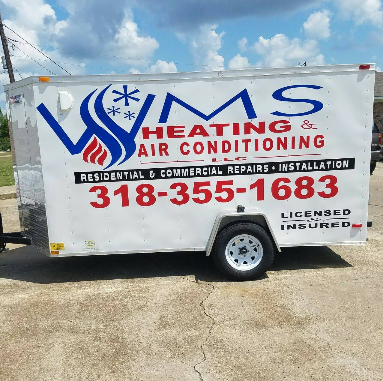 White trailer with "WMS Heating & Air Conditioning" branding, displaying contact info and services for residential and commercial repairs.