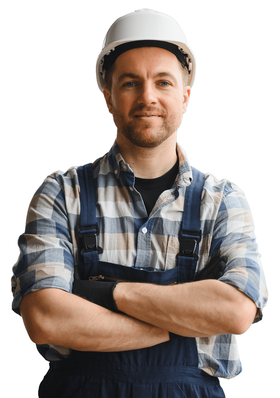 Construction worker wearing a hard hat and blue overalls, confidently crossing his arms. Represents teamwork and safety in the construction industry.
